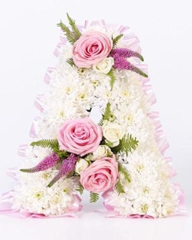 White Base Letter with Pink Ribbon and Spray Flower Arrangement