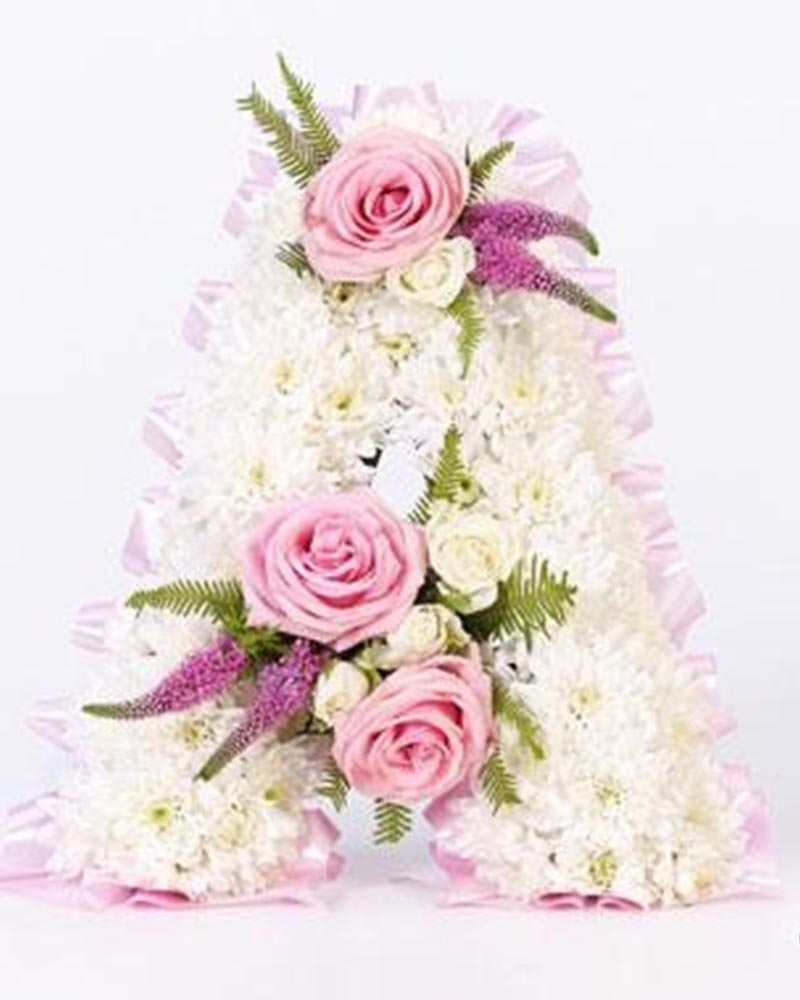 White Base Letter with Pink Ribbon and Spray Flower Arrangement