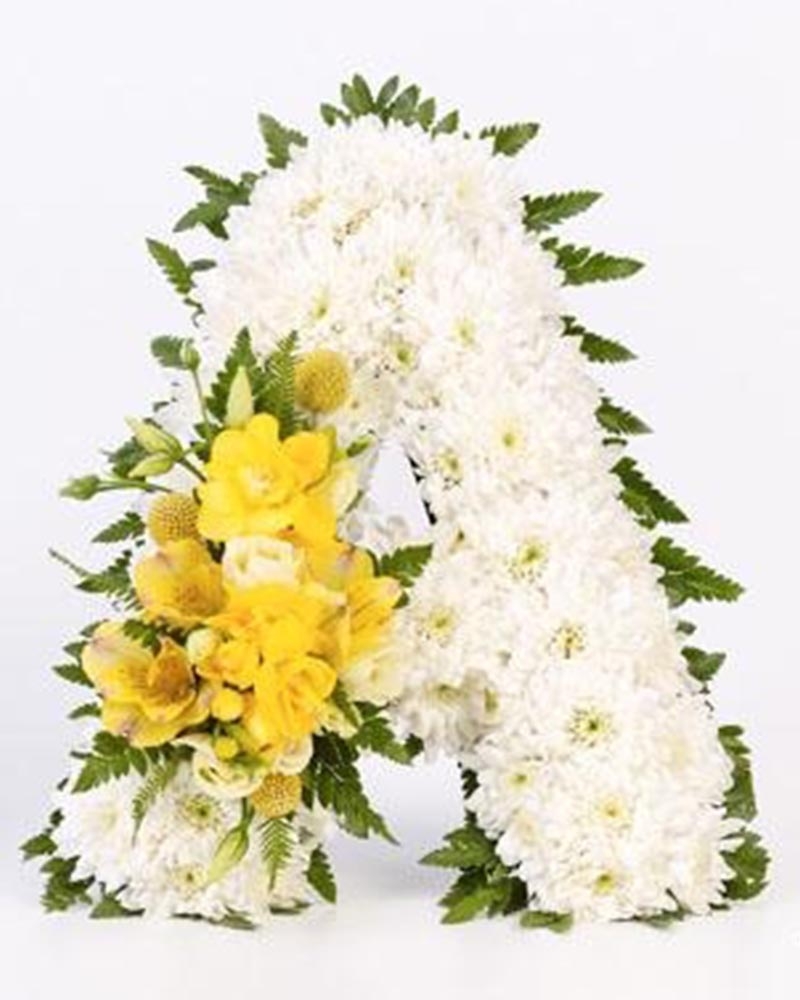 White Base Letter with Yellow Spray Flower Arrangement