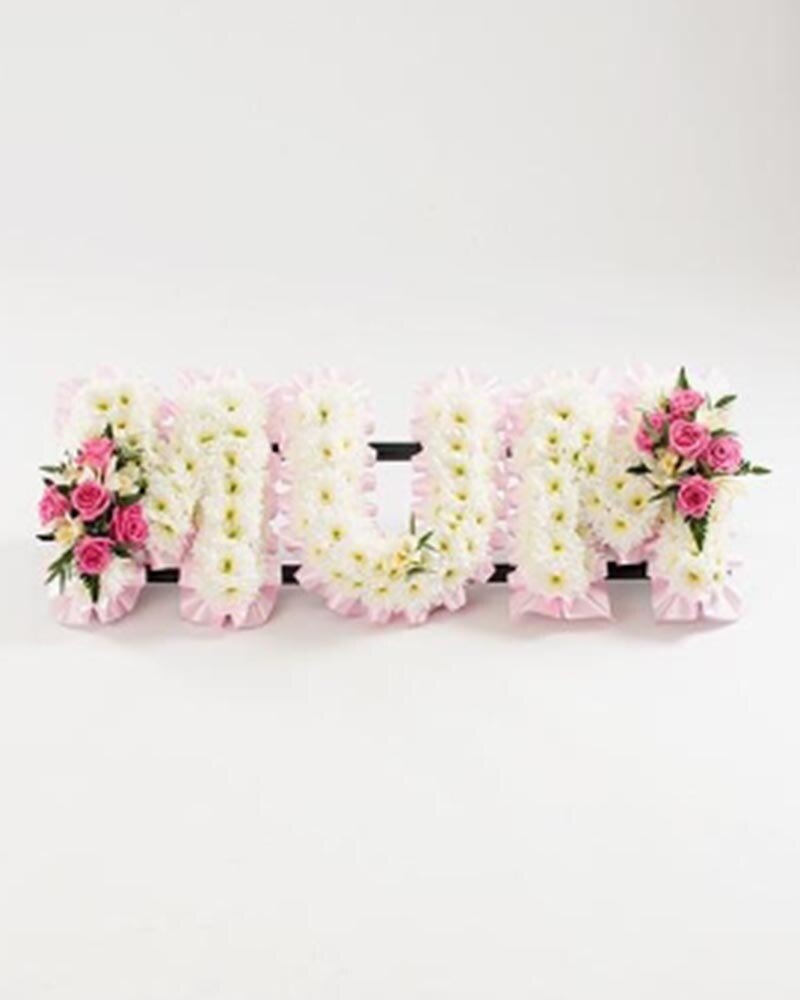 White Base Letter with Pink Ribbon and Spray Flower Arrangement