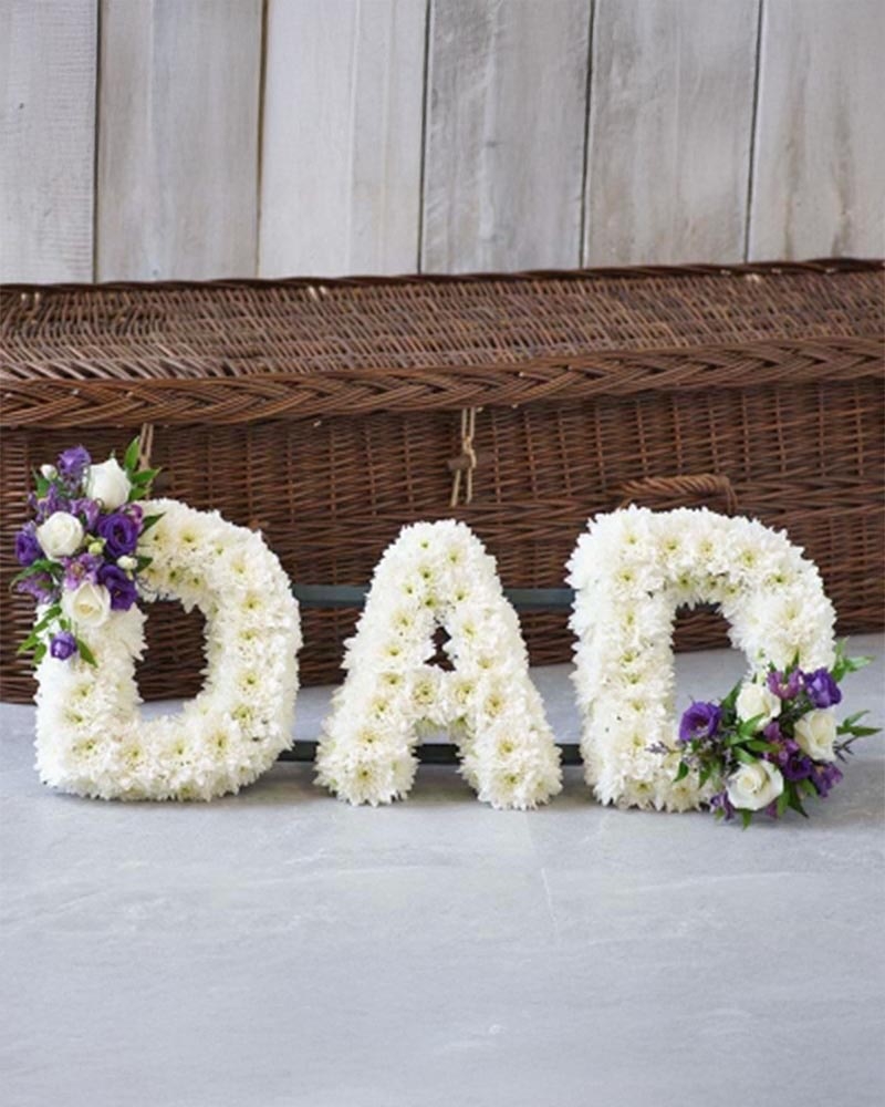 White Base Letter with Purple and White Spray Flower Arrangement