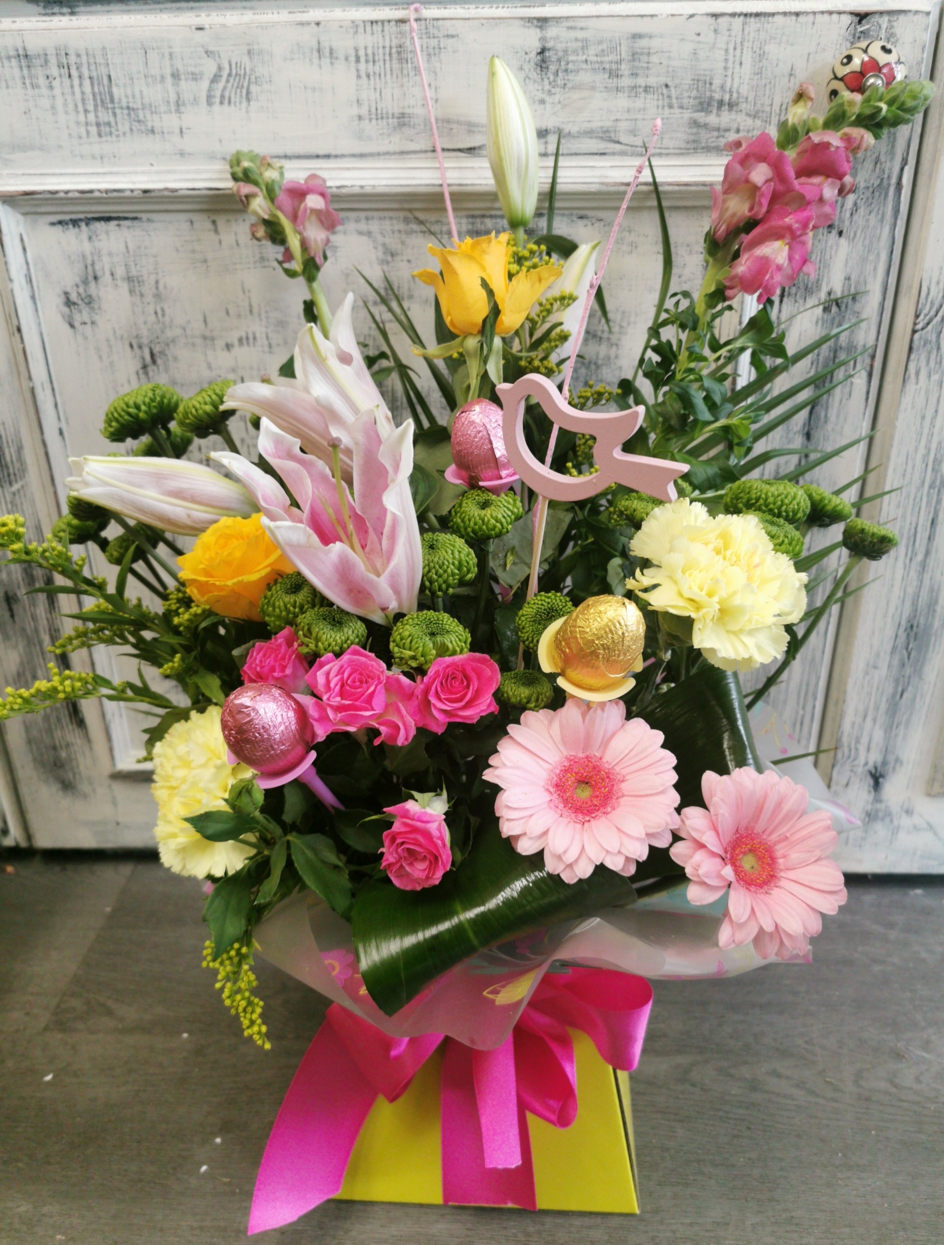 Pink and Yellow Front Facing Box with Chocolate Eggs Flower Arrangement
